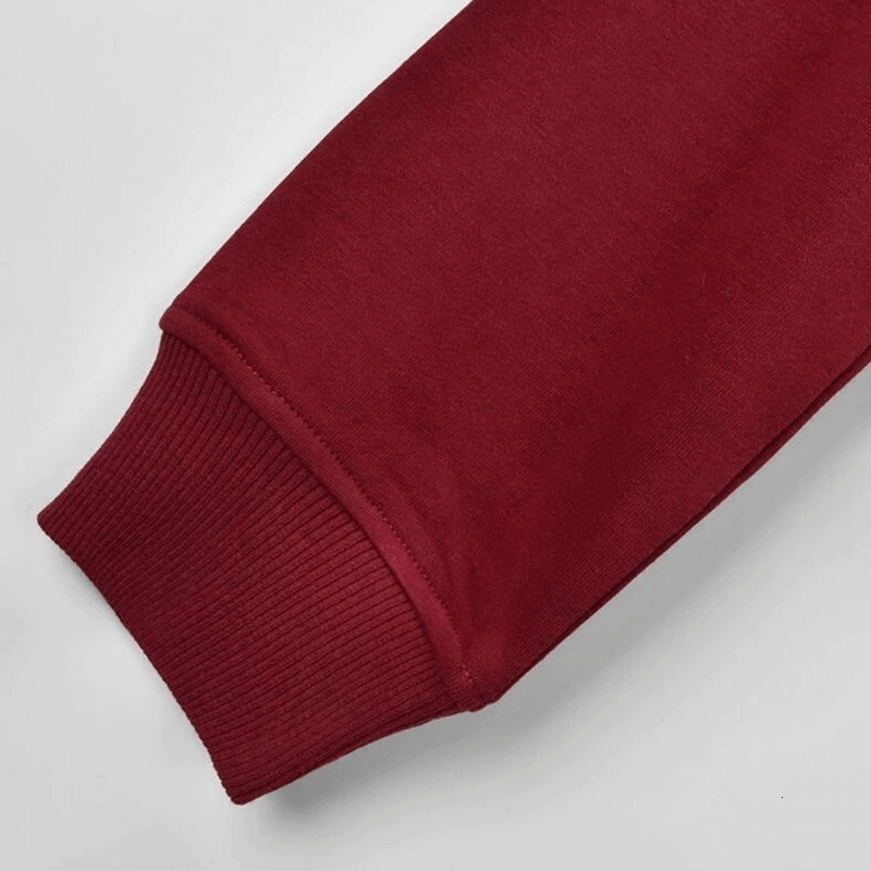 Maroon cuffed sleeve detail of a stylish women's sports hoodie, perfect for yoga and workouts, made from breathable materials.